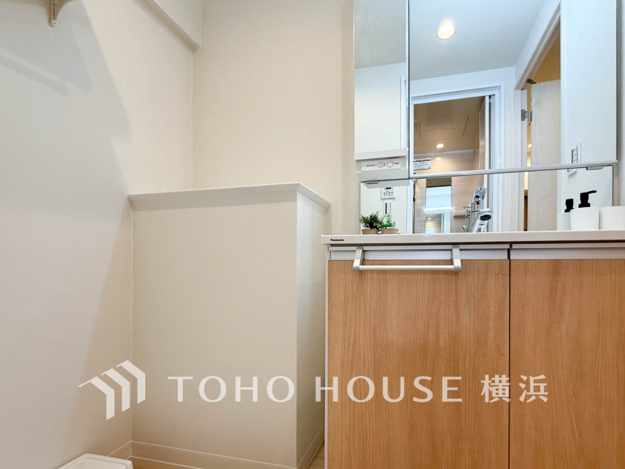 清潔感あふれる洗面スペース。収納力のある木目調キャビネットで使いやすさも抜群です。