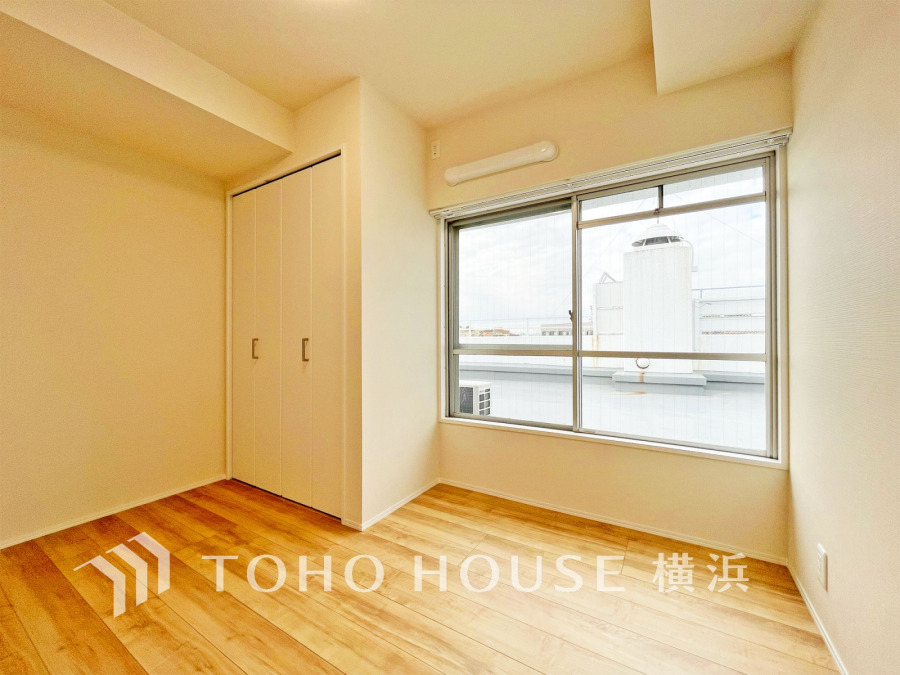 明るい自然光が差し込むクローゼット付きのシンプルな洋室。快適な住空間を実現します。