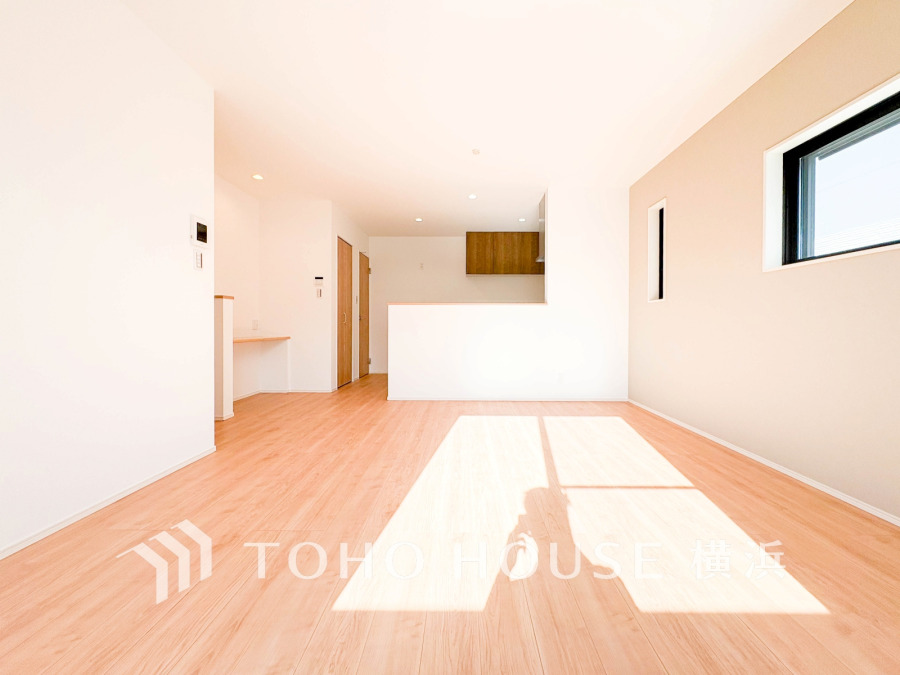 明るい自然光が差し込む、フローリングの開放的なリビングダイニングキッチンです。