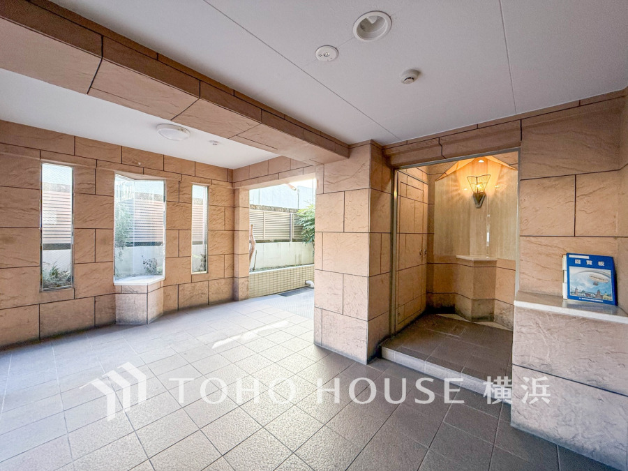 落ち着いた色調のタイル張りエントランス。自然光が差し込み、明るく開放的な空間が迎えます。