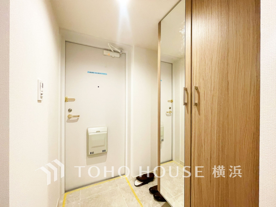 玄関には、大型のミラーのついたシューズボックスを設置。
