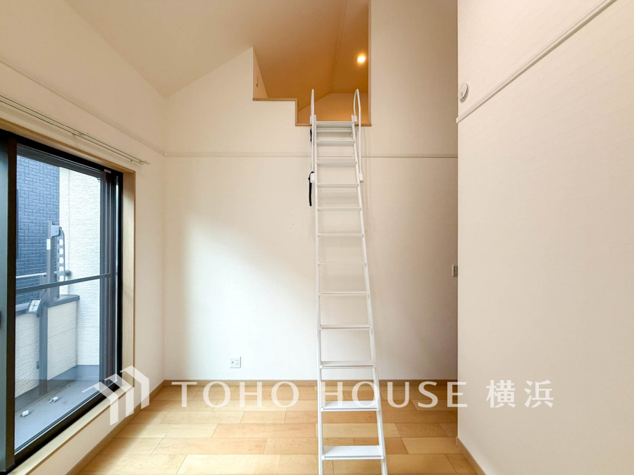 明るい自然光が差し込むシンプルな室内。ロフトへのアクセスに便利なはしご付きで空間を有効活用。