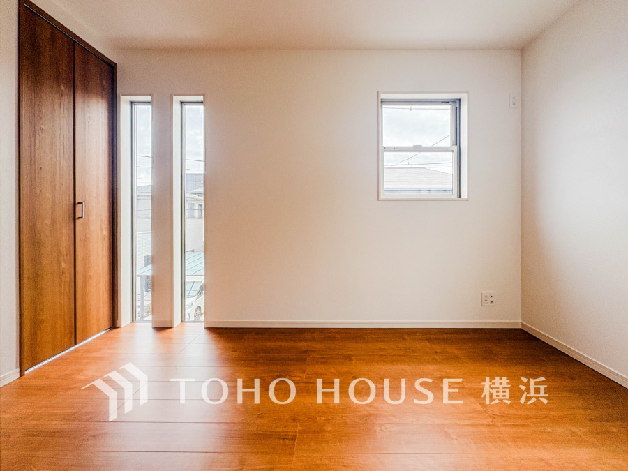 木目調のフローリングと明るい窓が調和した、シンプルで使いやすい洋室空間です。収納も充実しています。