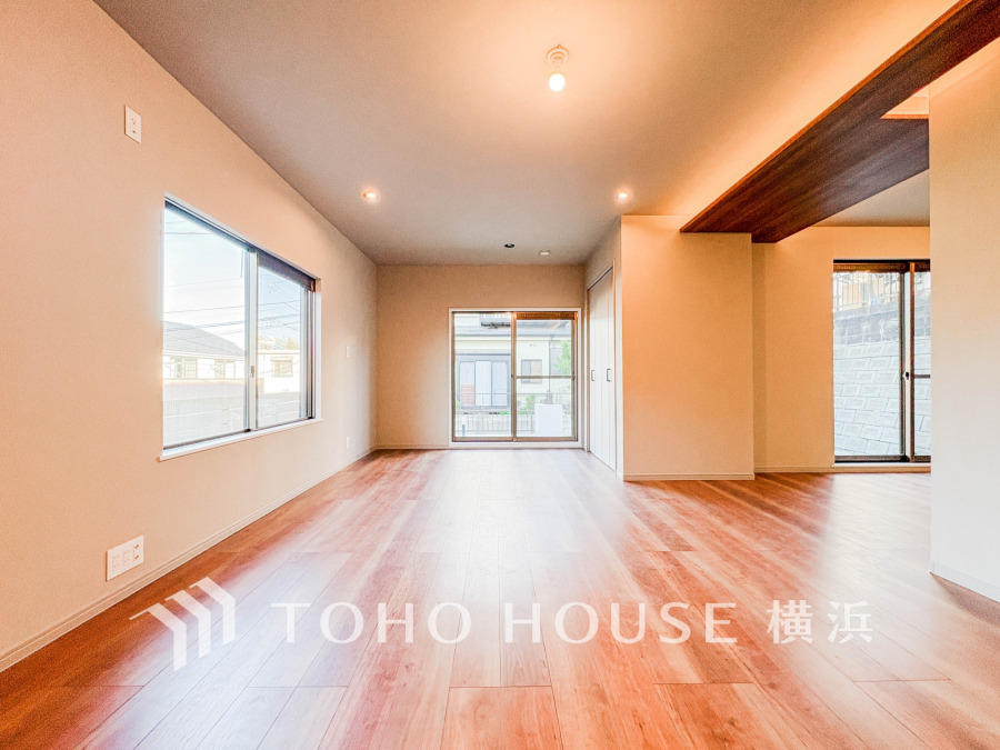 明るい自然光が差し込む広々としたリビング。木目調の床が温かみを演出し、快適な生活空間を実現します。