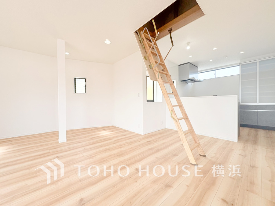 明るい自然光が差し込むリビングダイニング。便利な小屋裏収納へはしごで繋がります。