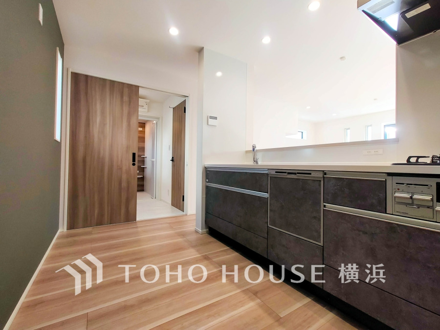 清潔感溢れるシステムキッチンは、ビルトイン食器洗浄乾燥機、浄水器内蔵型ハンドシャワーなど機能的な設備を備えています。