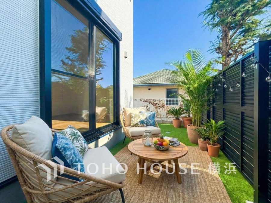 プライベート感ある庭でゆったり寛げる、緑と陽光に包まれた心地よいアウトドアリビング空間です。（家具はAI加工です）