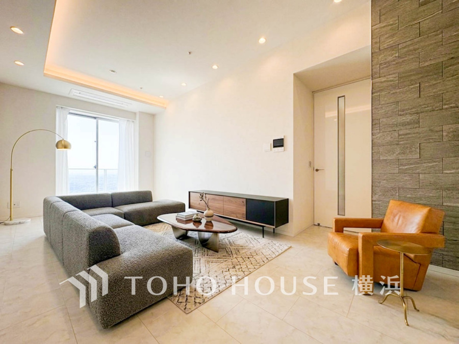 明るい自然光が差し込むリビングは、モダンな家具と調和した落ち着きのある空間です。（装飾品はAI加工です）