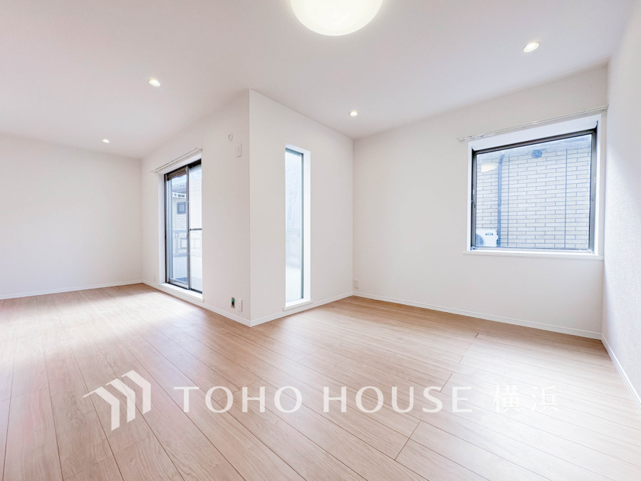 明るい自然光が差し込む、シンプルで開放感あふれるリビングルーム。快適な住空間です。