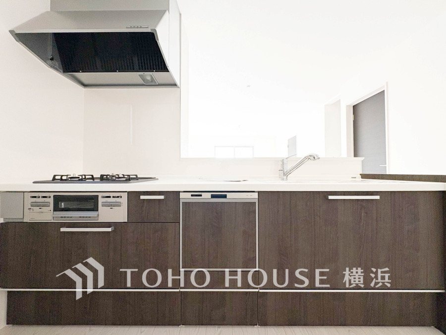 スタイリッシュな木目調キャビネットと使いやすい設備を備えた、開放感ある対面キッチンです。