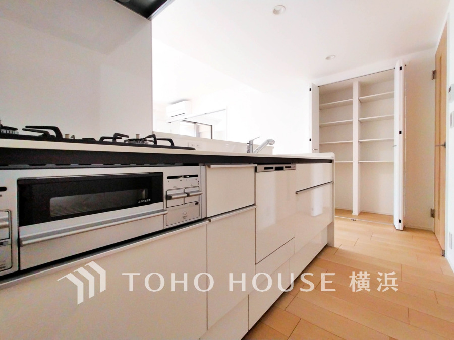 収納豊富で使い勝手の良いシステムキッチン。キッチン横にも便利なリビング収納付きです。