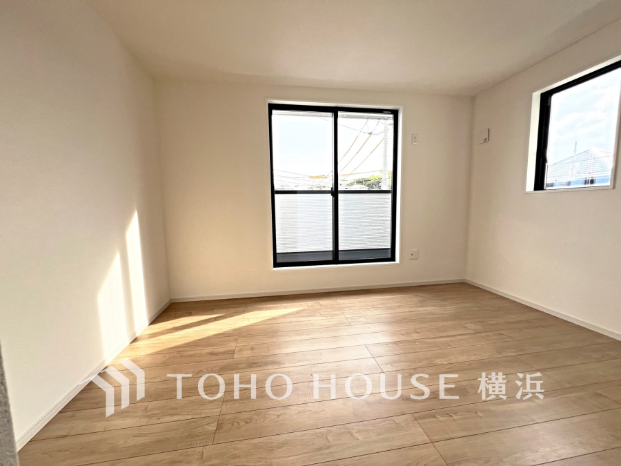 陽光が差し込む明るい居室。シンプルな白壁と木目調フローリングで、どんなインテリアも映えます。