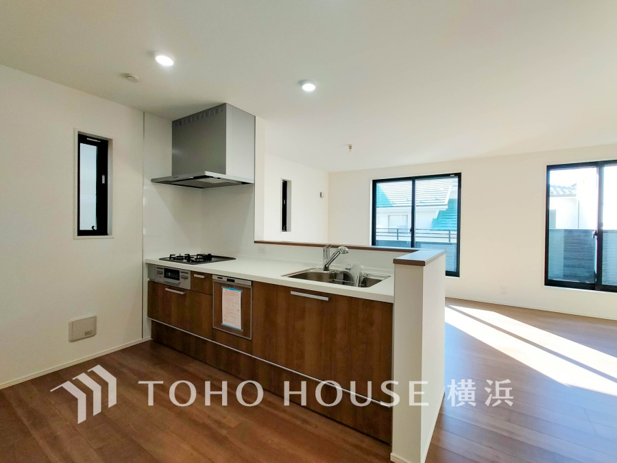 明るい自然光が差し込む、使い勝手の良い対面キッチンのある開放的なリビング空間です。