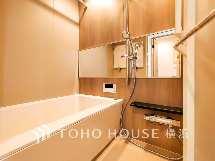 木目調パネルが温かみを演出する、清潔感あふれる浴室。