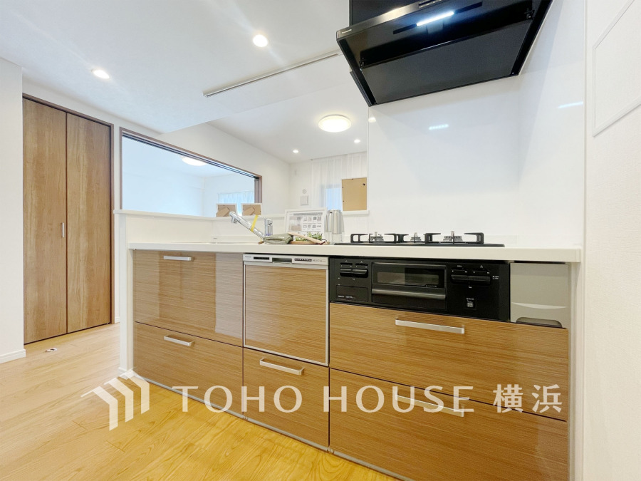 木目調の収納が美しい、開放感ある対面キッチン。家族との会話を楽しみながら調理ができます。