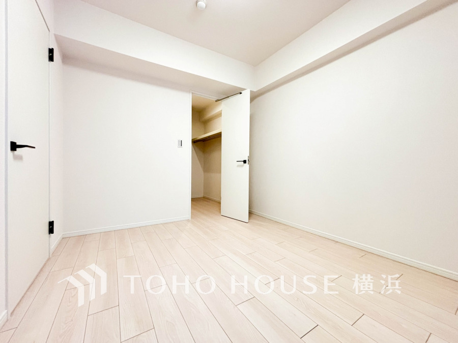 白を基調とした明るい洋室。ウォークインクローゼット付きで収納力も充実しています。