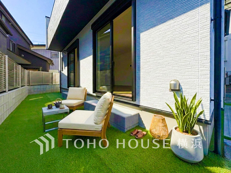 綺麗にデザインされたお洒落なお庭スペース。広さもあるのでお子様が遊んだり、ペットと戯れたりと楽しい時間を過ごせます。（装飾品はAI加工です）