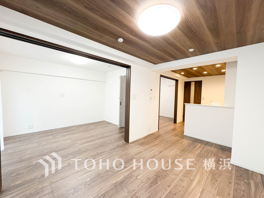 木目が美しい天井と床が調和した、明るく開放的なリビングダイニング空間です。家族の集いに最適です。