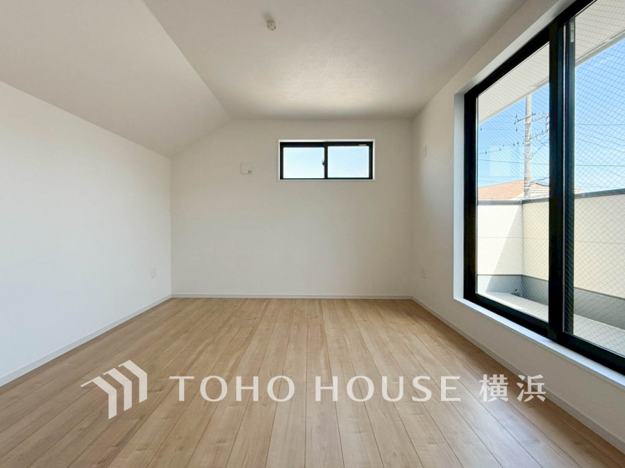 大きな窓から明るい光が差し込む、シンプルで開放感のある居室。清潔感あふれる空間です。