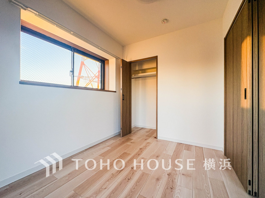 明るい自然光が差し込む、広々とした収納付きの洋室。シンプルで使いやすい空間です。