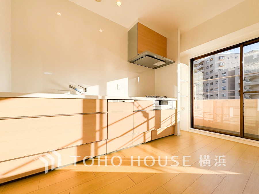 陽光が差し込む明るいキッチン。収納豊富で使いやすく、バルコニーに面した開放感ある空間です。
