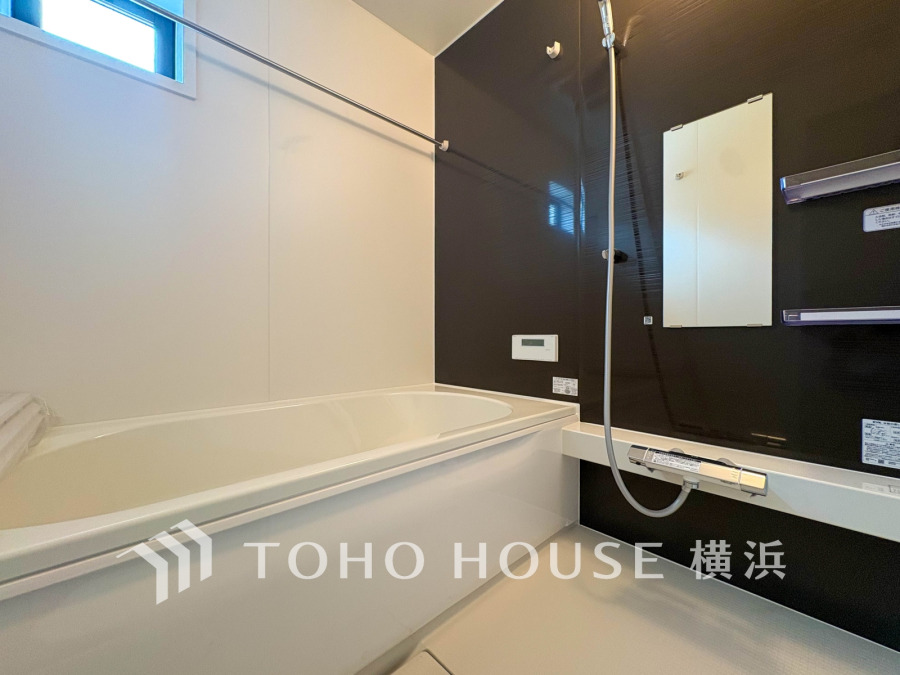 清潔感あふれるシンプルなデザインのバスルーム。ブラックアクセントが落ち着いた空間を演出します。