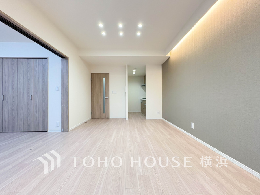 シンプルで明るいリビングは間接照明がアクセント。隣接の洋室と繋げて広く使える快適な空間です。