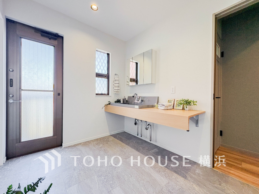 自然光が差し込む清潔感あふれる洗面スペース。広々とした空間で快適な身支度が叶います。